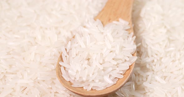 Uncooked White Rice and Wooden Spoon