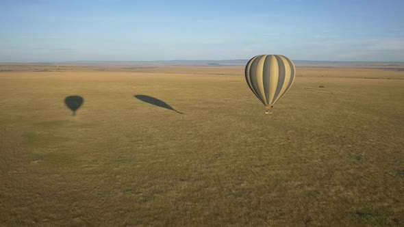 Aerial of a hot air balloon flying over the savannah