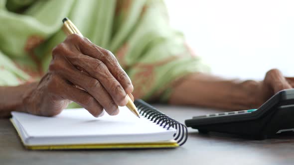 Close Up of Senior Women Hand Writing on Notepad