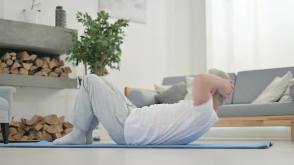 Old Man Doing Workout on Yoga Mat at Home