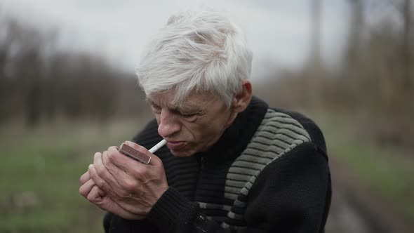 Rural Man Lights a Cigarette