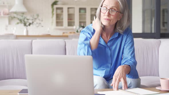 Senior Older Woman Elearning Watching Webinar on Laptop at Home