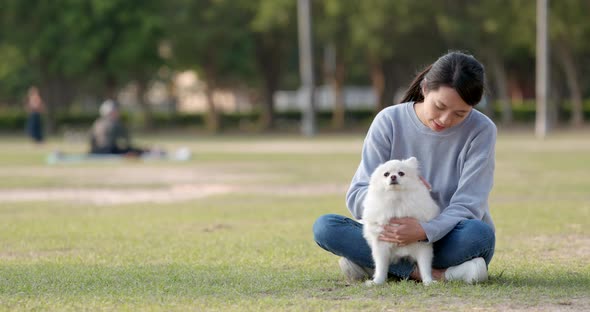 Woman play with her dog at outdoor park