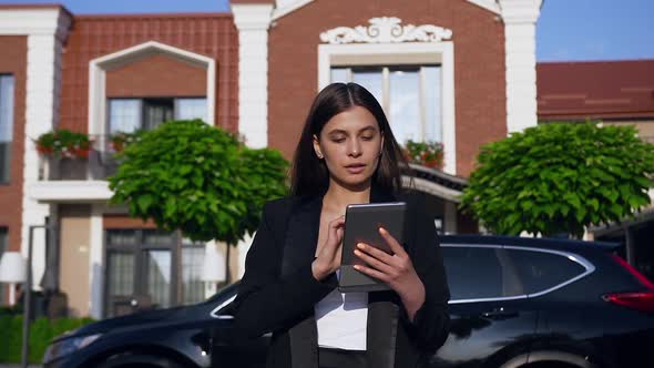 Successful Young Woman in Formal Costume Using Tablet Computer Texting Checking Email