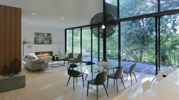 Time lapse of interior of luxury home with light passing across the room with forest view.