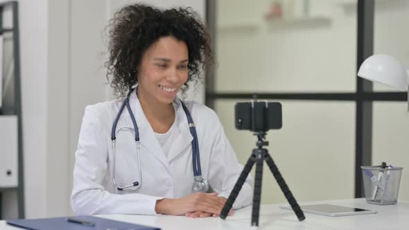 Female African Doctor Recording Video on Smartphone Video Chat