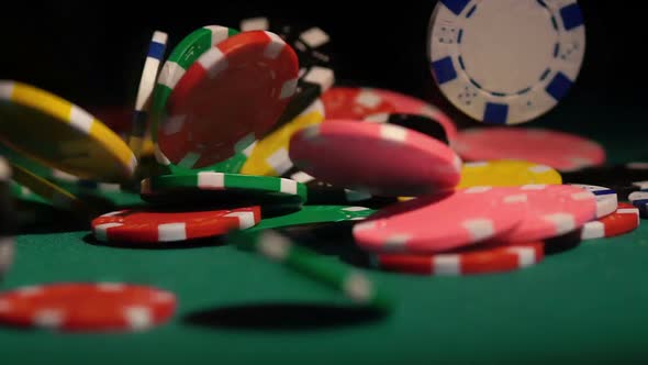 Winning Jackpot in Casino, Many Poker Chips Falling on Green Table in Slowmotion