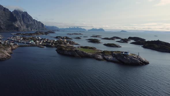 Flying at the coast of Henningsvaer overlooking the many connected islands of Henningsvaer and the f