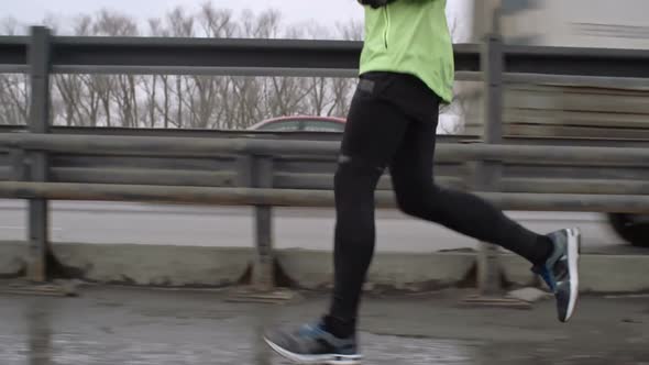 Young Man Athlete Training for Marathon on Bridge