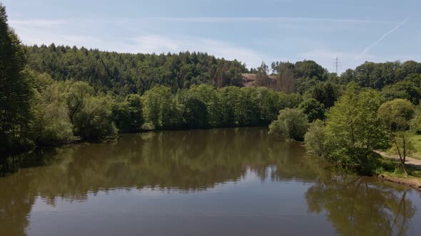 Lush and leafy nature along the river banks of the sieg in North Rhine Westphalia, Germany. Low aeri