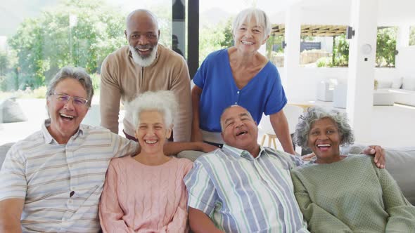 Portrait of senior diverse people embracing at retirement home