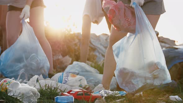 Close Up Shot of Group of Eco Volunteers Cleaning Up Area of Dump Near the Field