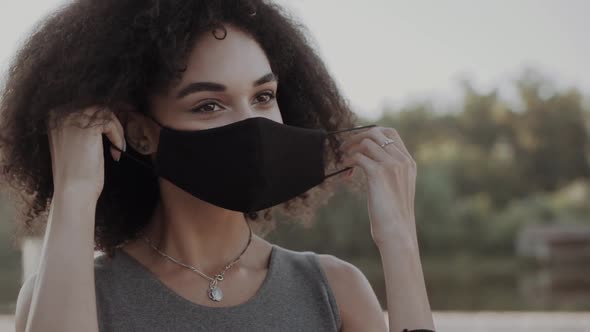 Mixed Race African American Teenager Teen Girl Young Woman Wearing a Face Mask Outside During the