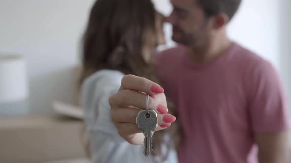 Happy Young Woman Holding Keys From New Apartment