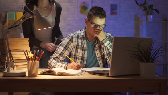 Portrait of a Young Family Man Overworked Sitting at a Laptop at Night