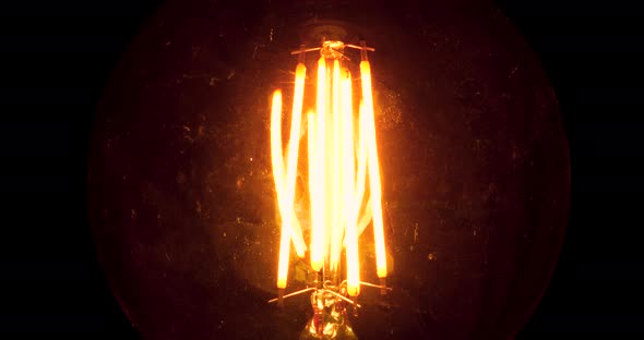 Edison Lamp Flicker At Night. Dirty Light Bulb Glass With Scratches Evokes Horror