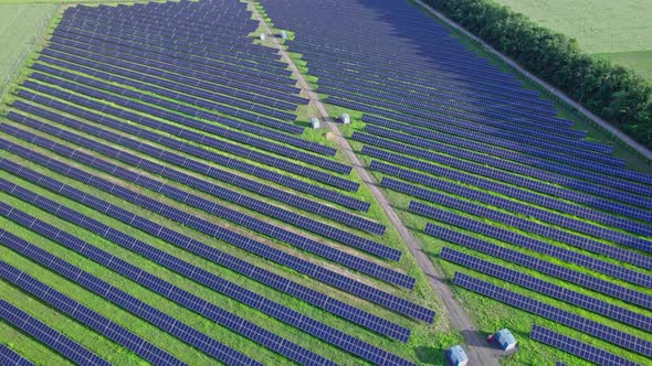 Aerial View of Solar Panels Stand in a Row in the Fields