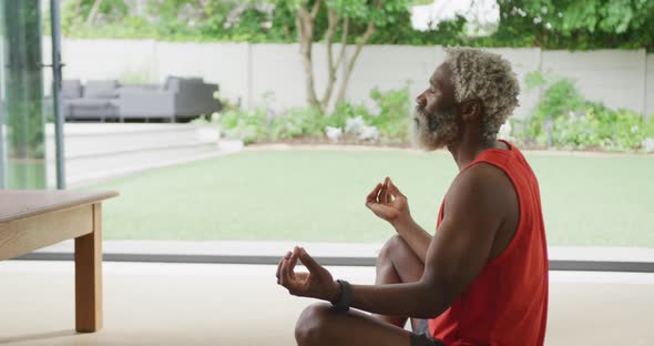 Video of african american senior man meditating