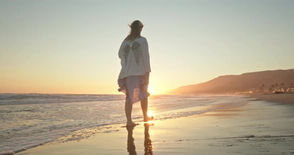 Inspirational Slow Motion Footage with Young Traveler Walking By Beach at Sunset