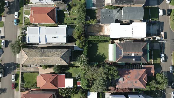 Top down view on residential area comprising of modern Australian houses surrounding a woodland beac