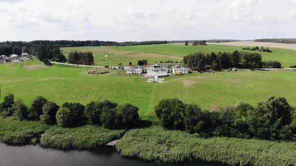 Aerial View of Country Cottage with Outbuildings in the Countryside By the River and Delightful