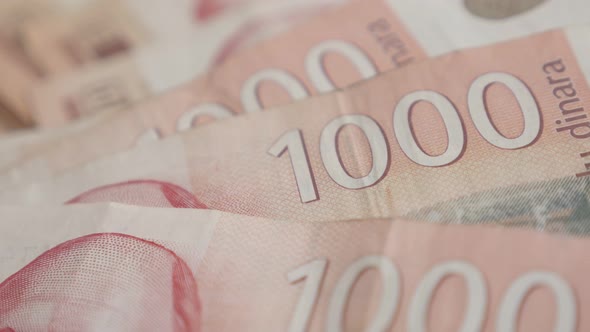 Shallow DOF denominations of 1000 dinars 4K 2160p 30fps UltraHD panning footage - Serbian banknotes 