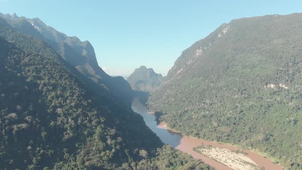 Aerial: flying over Nam Ou River Nong Khiaw Muang Ngoi Laos, scenic valley