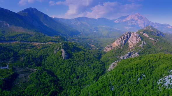 Aerial View of Mountain Peaks Covered with Beautiful Green Forests
