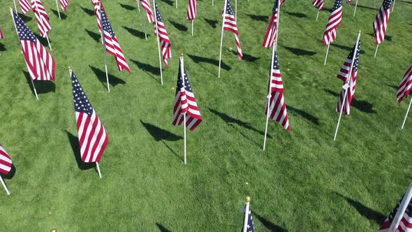 Flying backwards over American Flag display at park alt