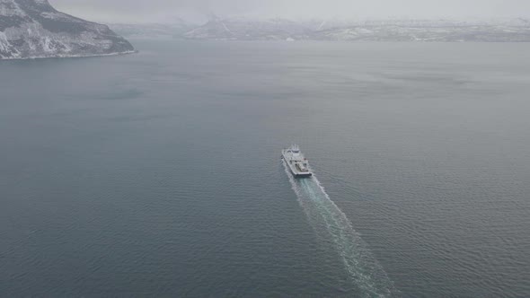 Aerial view of Ferry sailing in Northern Norway natural seascape on a winter cloudy day