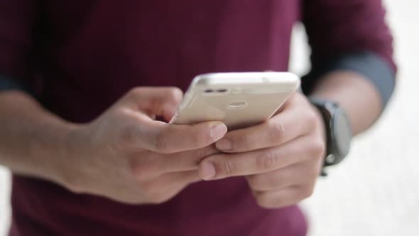 Close Up Shot of Mixed-race Male Hands Texting on Phone