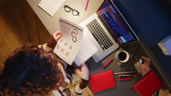 Businesswoman Working with Financial Data during Night