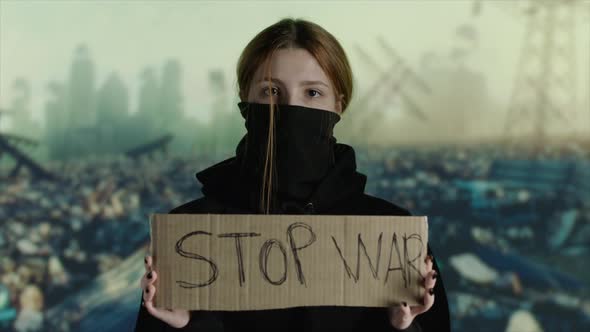 Woman Wearing Face Mask with STOP WAR on Cardboard Destruction on Background