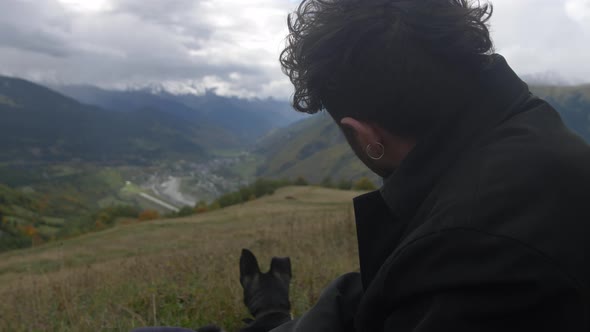 a Young Man and a Dog Climbed a Mountain and are Now Chilling