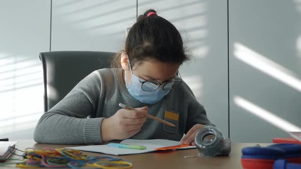 Masked Child in a School Class