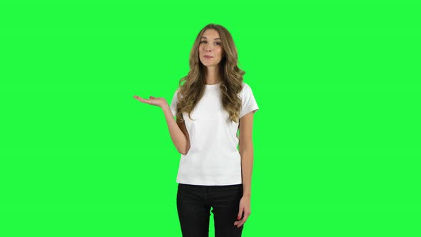 Lovable Girl Talking and Pointing Side Hand for Something, Copy Space. Green Screen