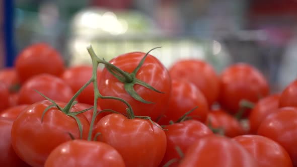 Ripe Fresh Red Tomatoes on a Rack in a Supermarket