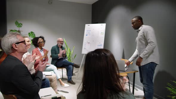 Afro-American Male Business Coach Entering Seminar Room and Giving Lecture