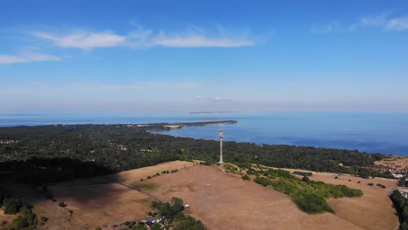 Aerial view of the coastline of Sejerøbugten with hills, fields and ocean.