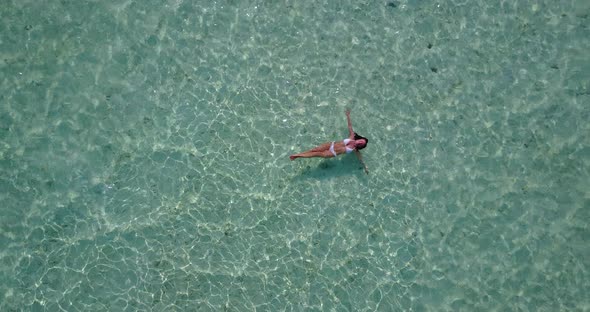 Sexy fun woman on vacation spending quality time at the beach on summer white sand and blue backgrou