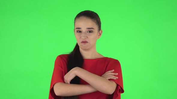 Portrait of Pretty Young Woman Is Saying Wow, Waves Her Head Approvingly. Green Screen