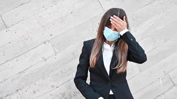 Sick Young Businesswoman Wearing Face Mask, Coughs Into Her Elbow. Ill Female Worker Having