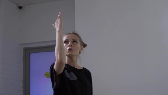 Young European Girl Rehearsing a Dance in the Studio in Front of the Mirror