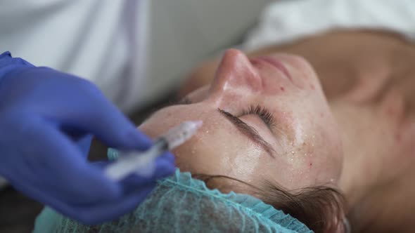 Woman on the Procedure of Mesotherapy Injection with a Syringe