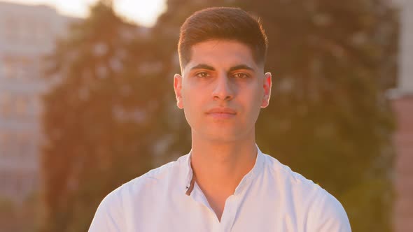Serious Focused Millennial Indian Male Student Posing Looking at Camera Outdoors
