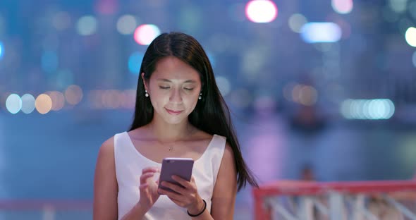 Woman use of mobile phone at night