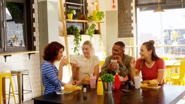 Executives interacting while having lunch at table 4k