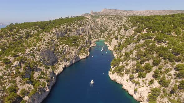 Aerial travel drone view of clear green water, cliffs of Cassis, Mediterranean Sea, Southern France.