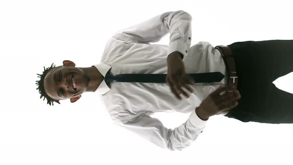 AfricanAmerican Man in a White Shirt Smiles and Confidently Crosses His Arms Over His Chest