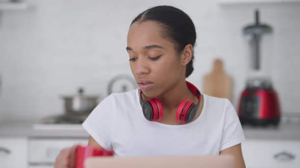 Beautiful Intelligent Young Slim Woman Drinking Morning Coffee in Kitchen Typing on Laptop Keyboard